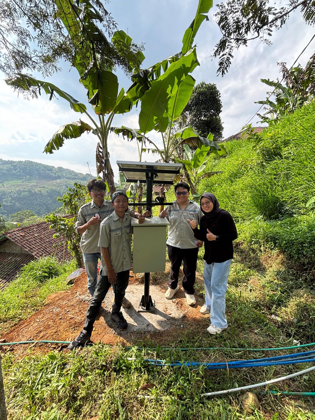 Team with the installed solar-powered EWS station