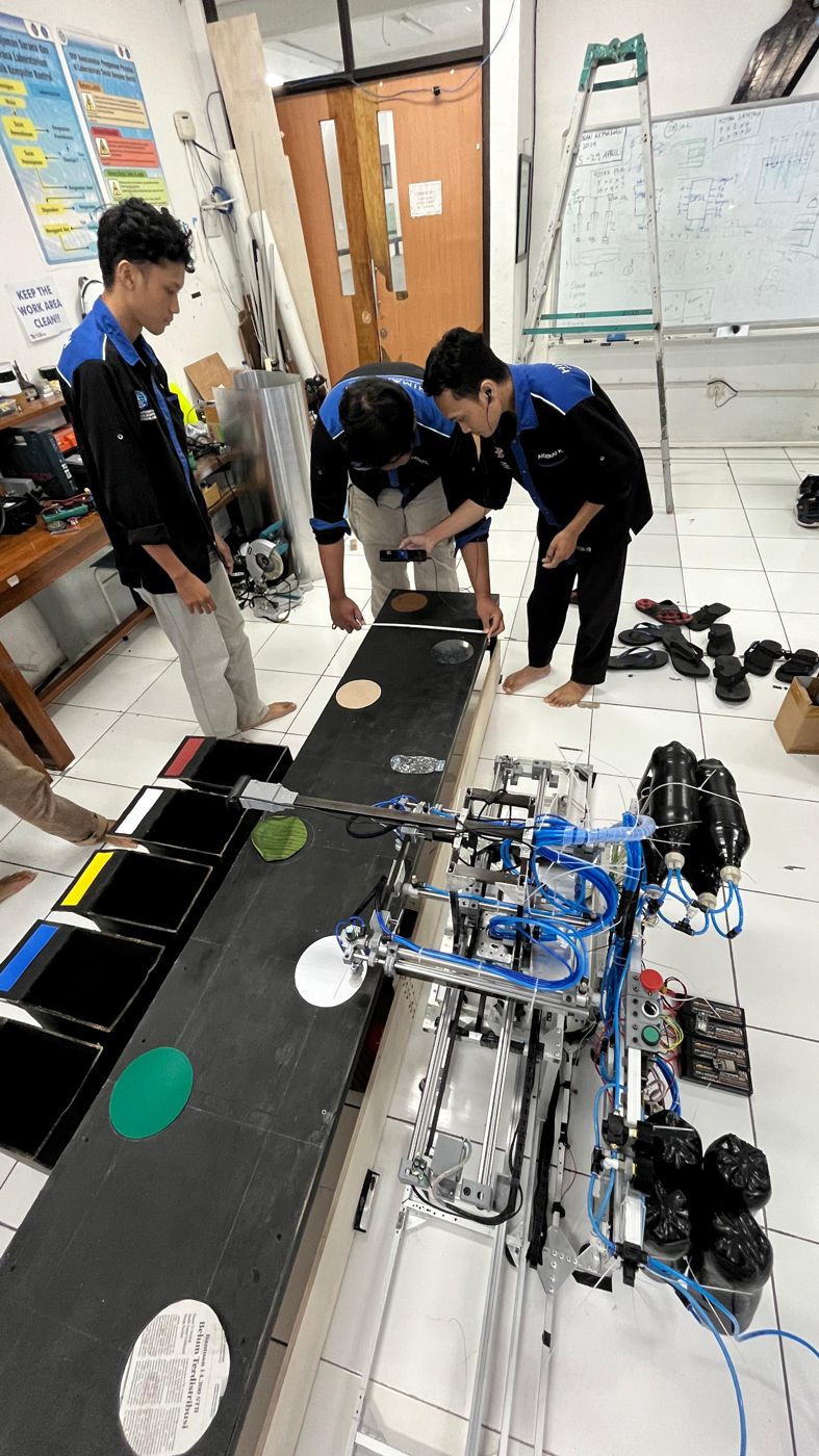 Team testing the waste-sorting robot on the practice field with sorting bins